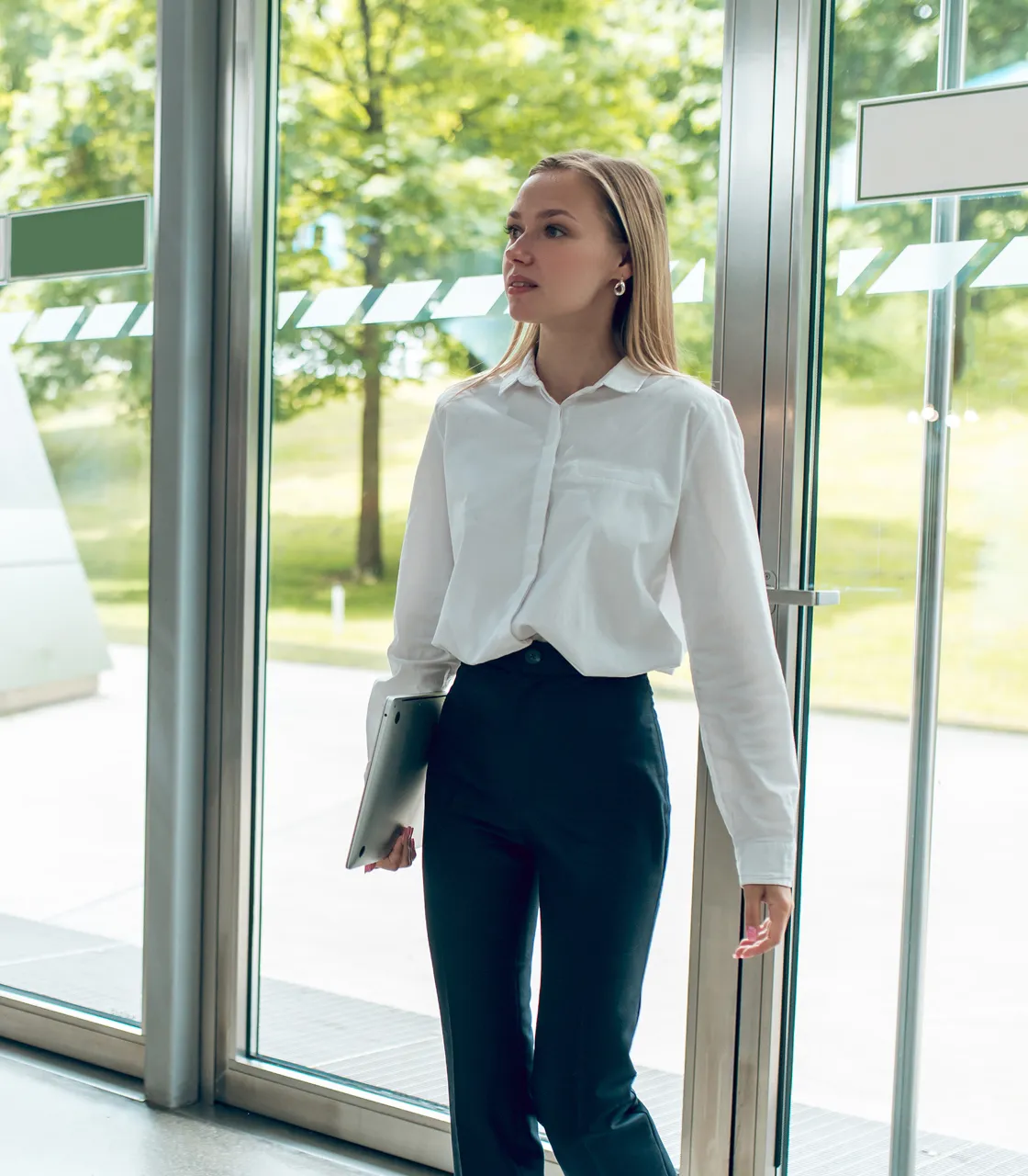 A woman in a white shirt and black pants.