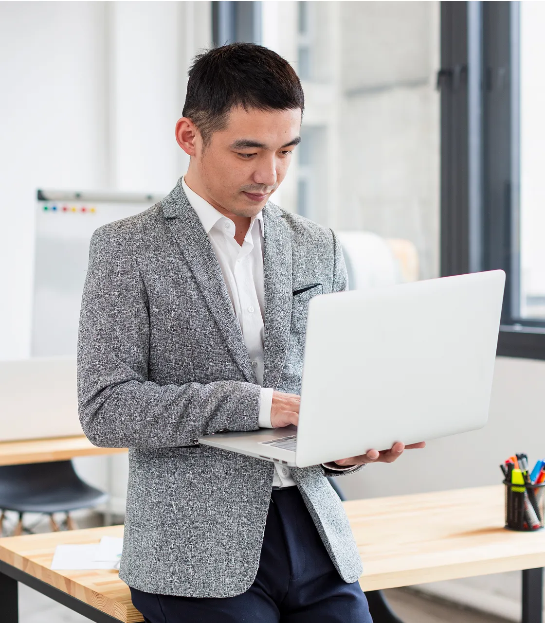 A man in a suit using a laptop computer.