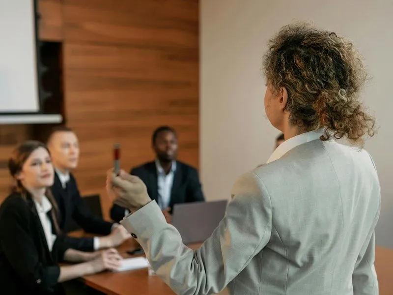 A woman giving a presentation to a group of people.