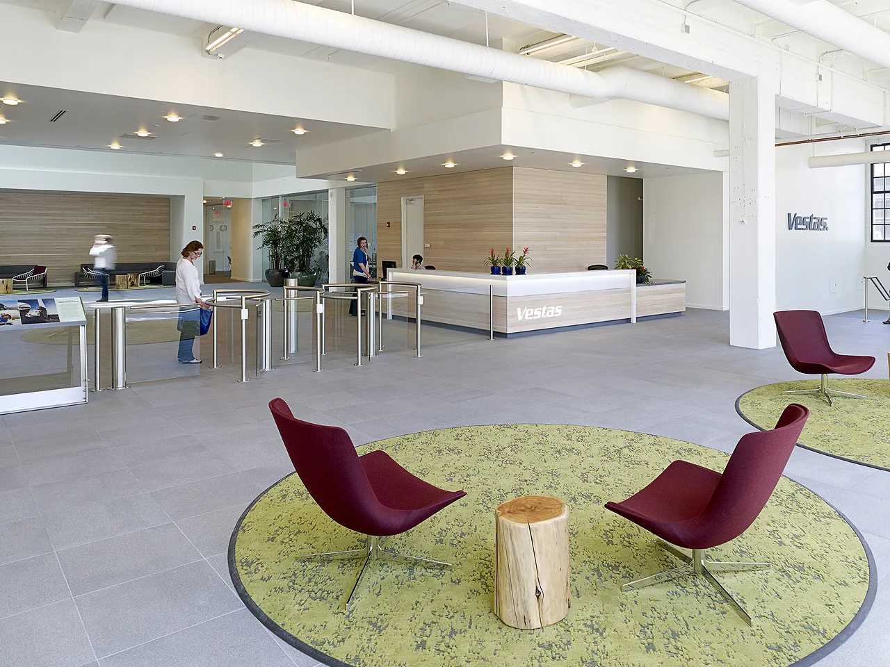 A couple of red chairs sitting on top of a green rug.