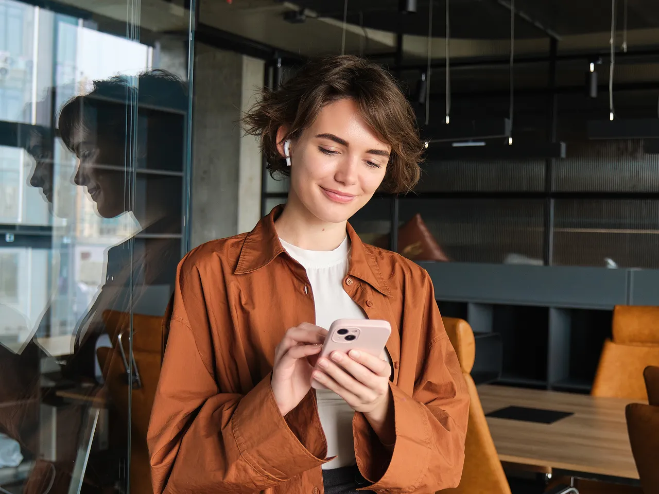 A woman is looking at her cell phone.