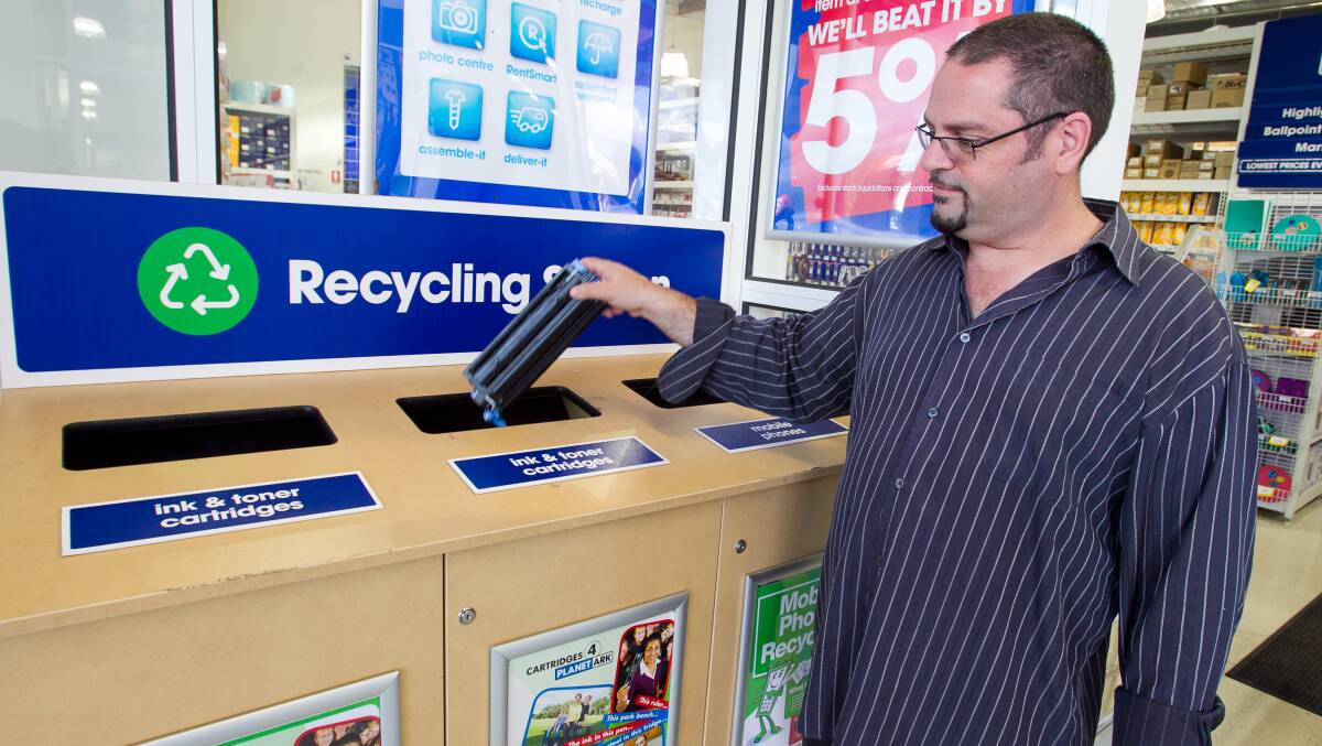 Customer dropping off a cartridge at a retail recycling station