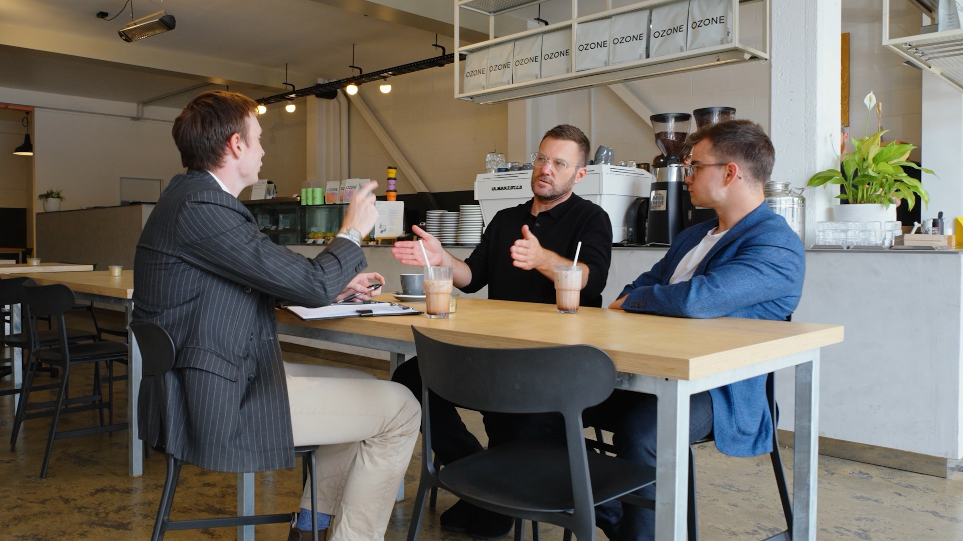 Still from the Gerrards About Us film, three people meeting over coffee at a Christchurch cafe