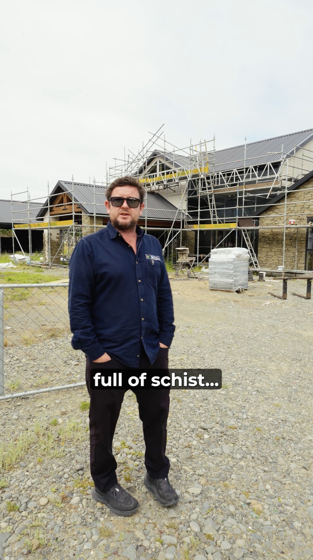 Still from a social video of a team member speaking on site in front of a build in progress