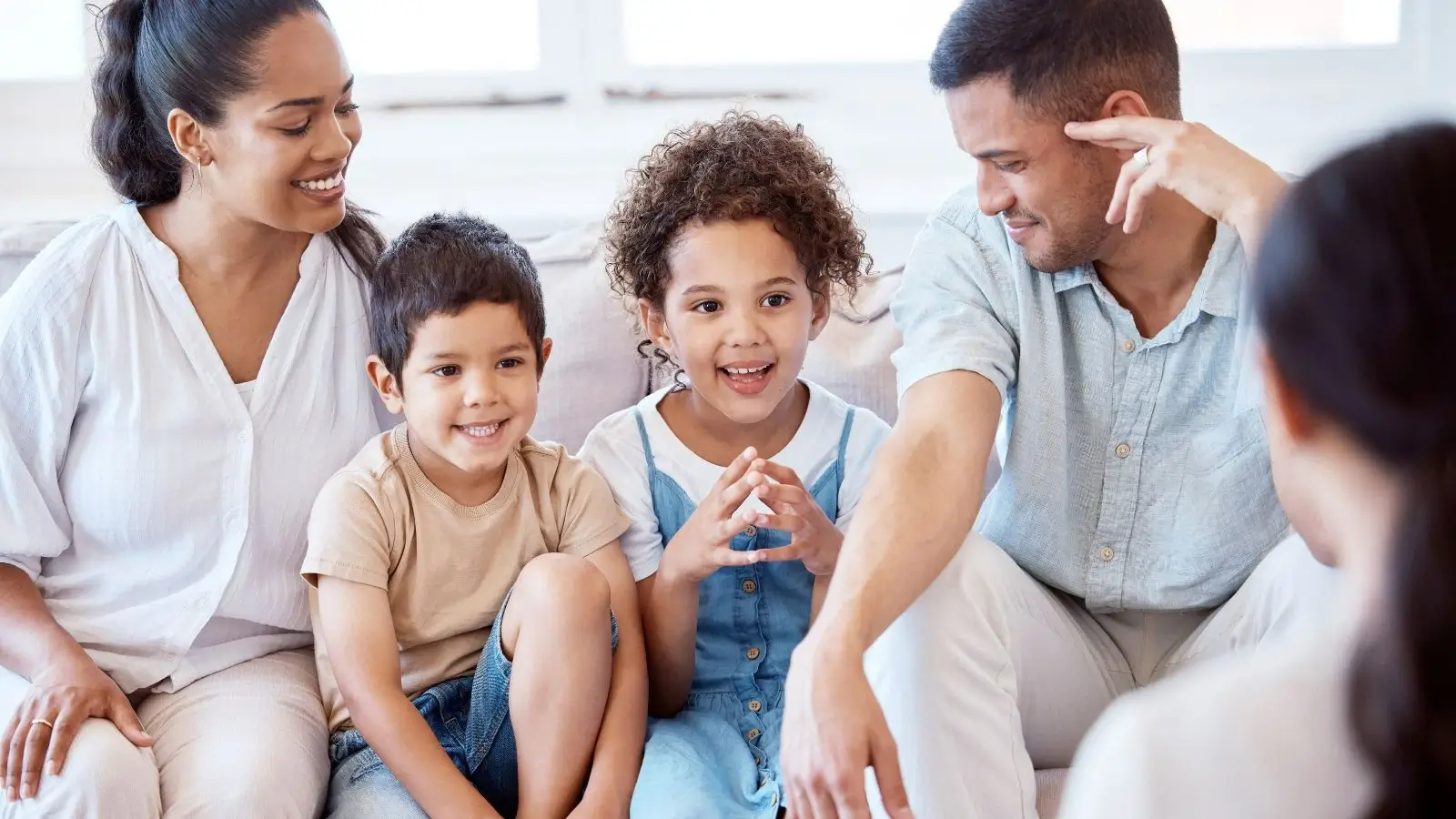 Parents with their two kids speaking with a counsellor