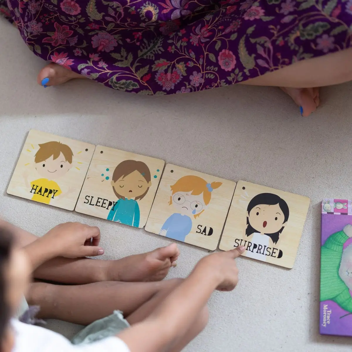 A child looking through four emotion cards