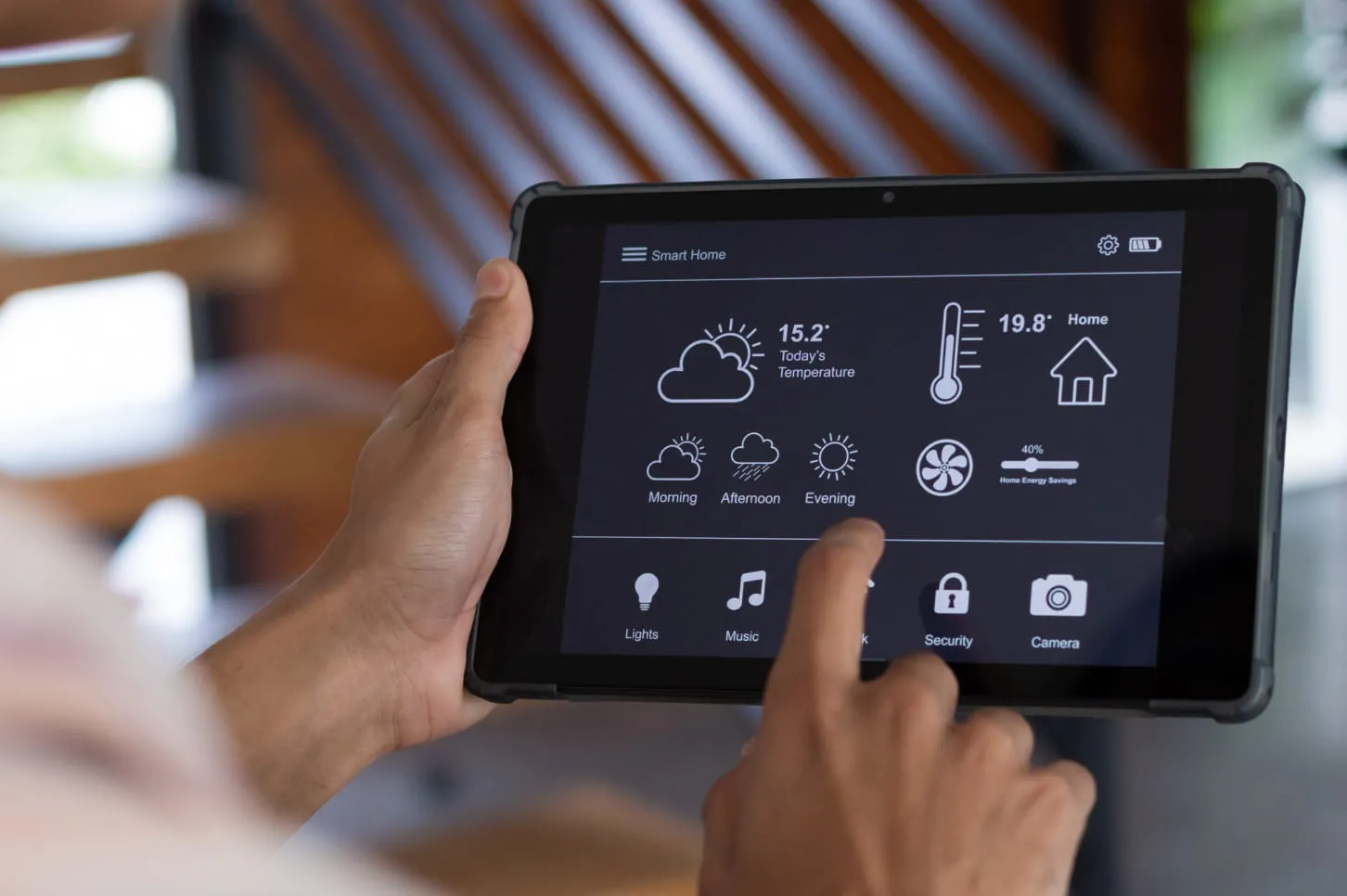 A person holding a tablet with a screen showing a weather system.