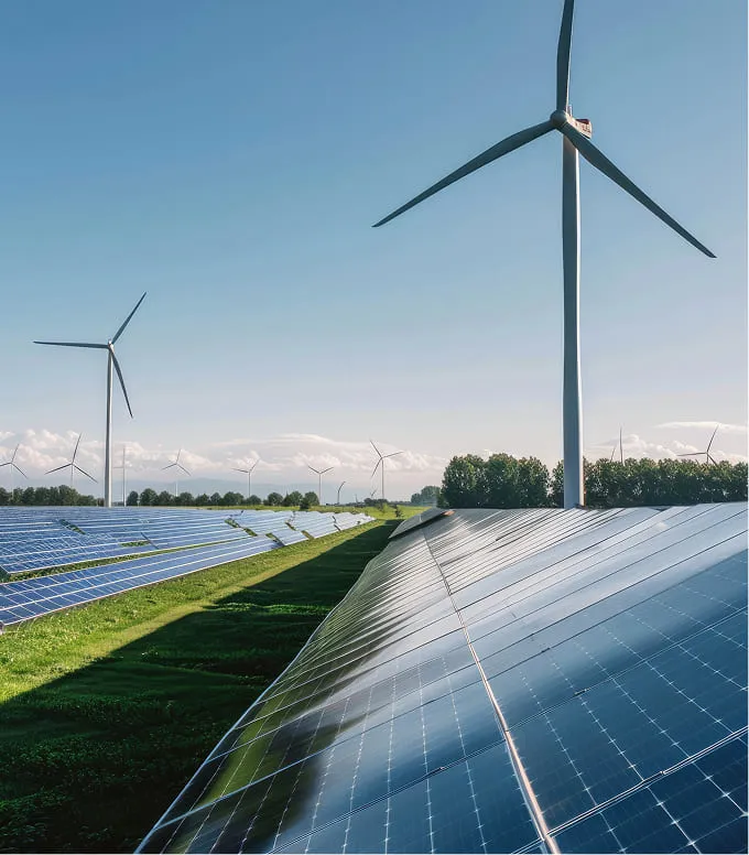 Solar panels and wind turbines on a sunny day.