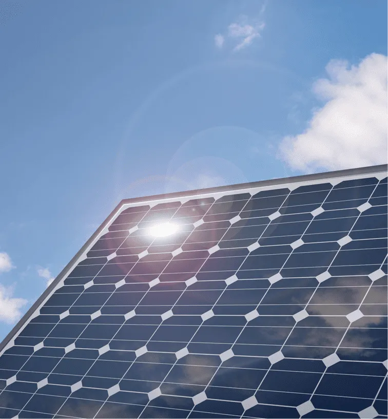 The sun shines brightly on a solar panel.