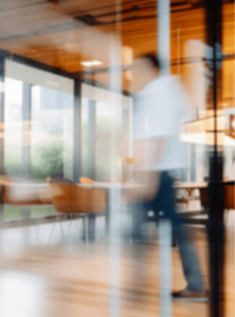 A blurry photo of a person walking in a room.