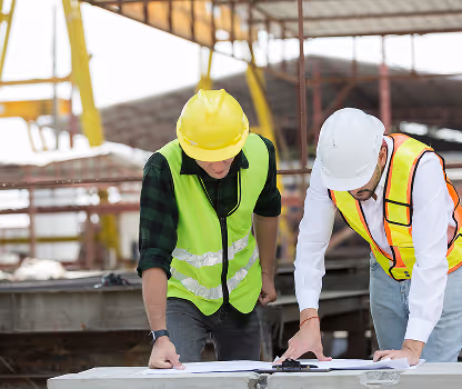 Two builders discuss plans.
