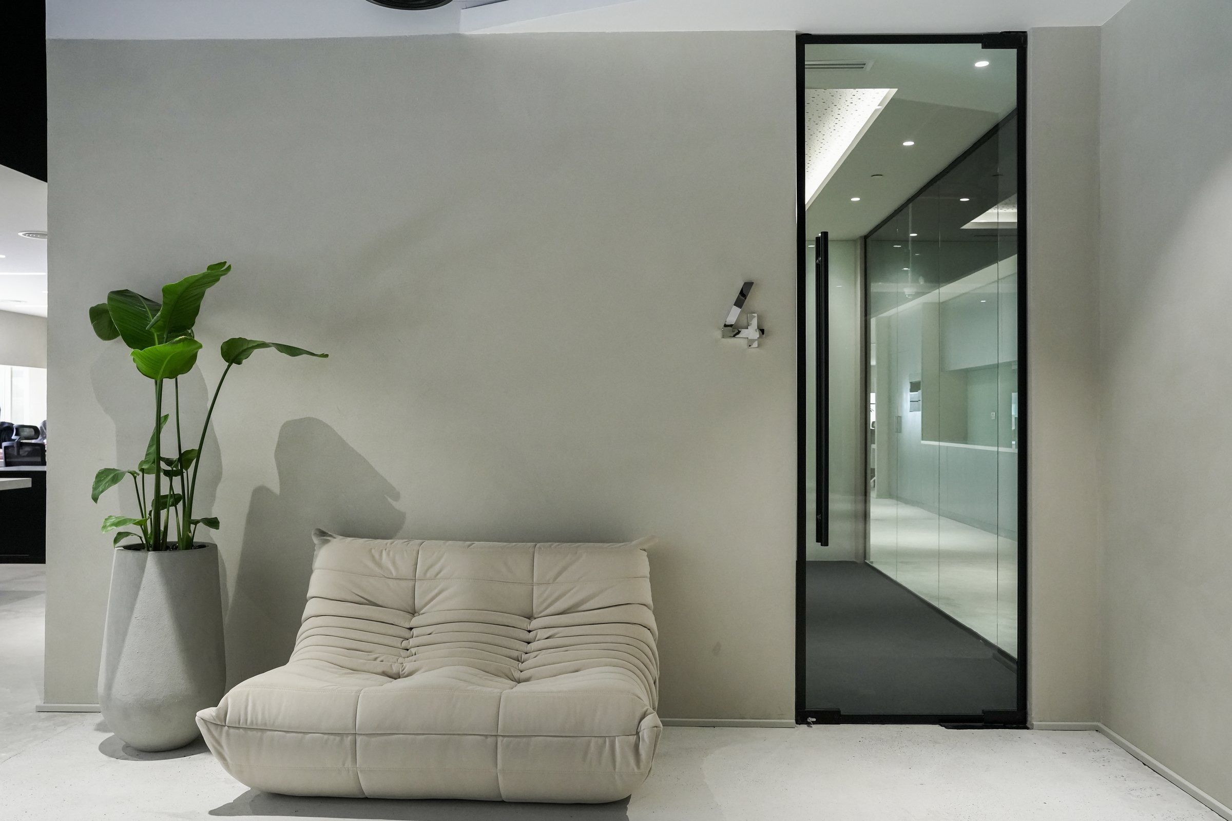 Cream lounge chair beside glass door, creative studio, JAFZA