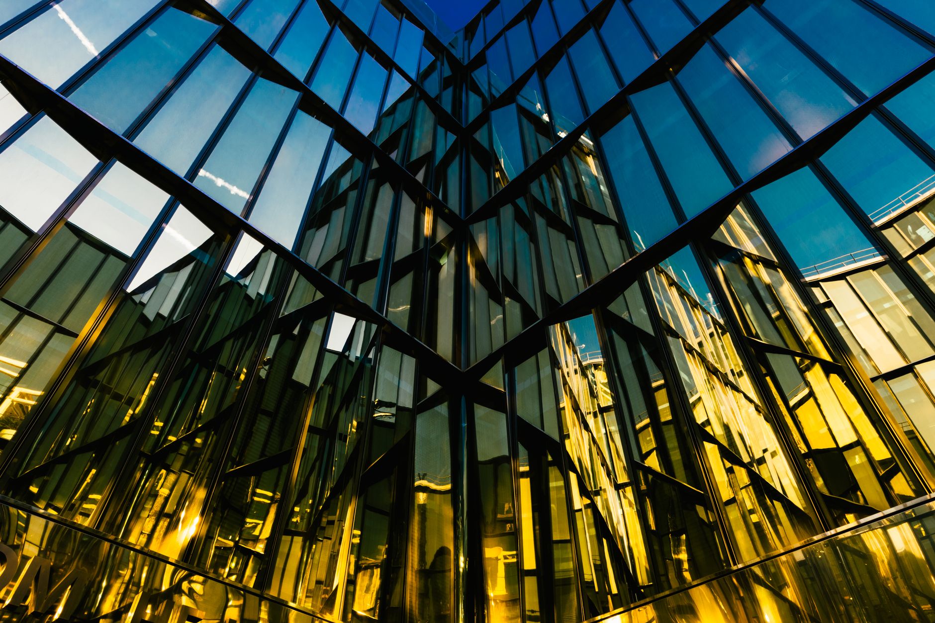 A modern building with a mirrored facade reflecting the sky — Healthcare Infrastructure