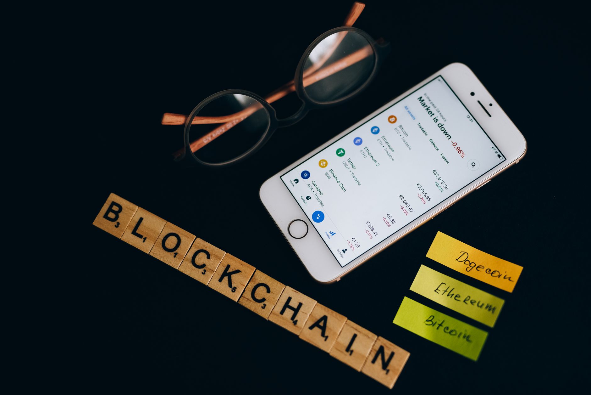 Smartphone displaying cryptocurrency market data alongside blockchain concept elements — Digital Money & Securitization
