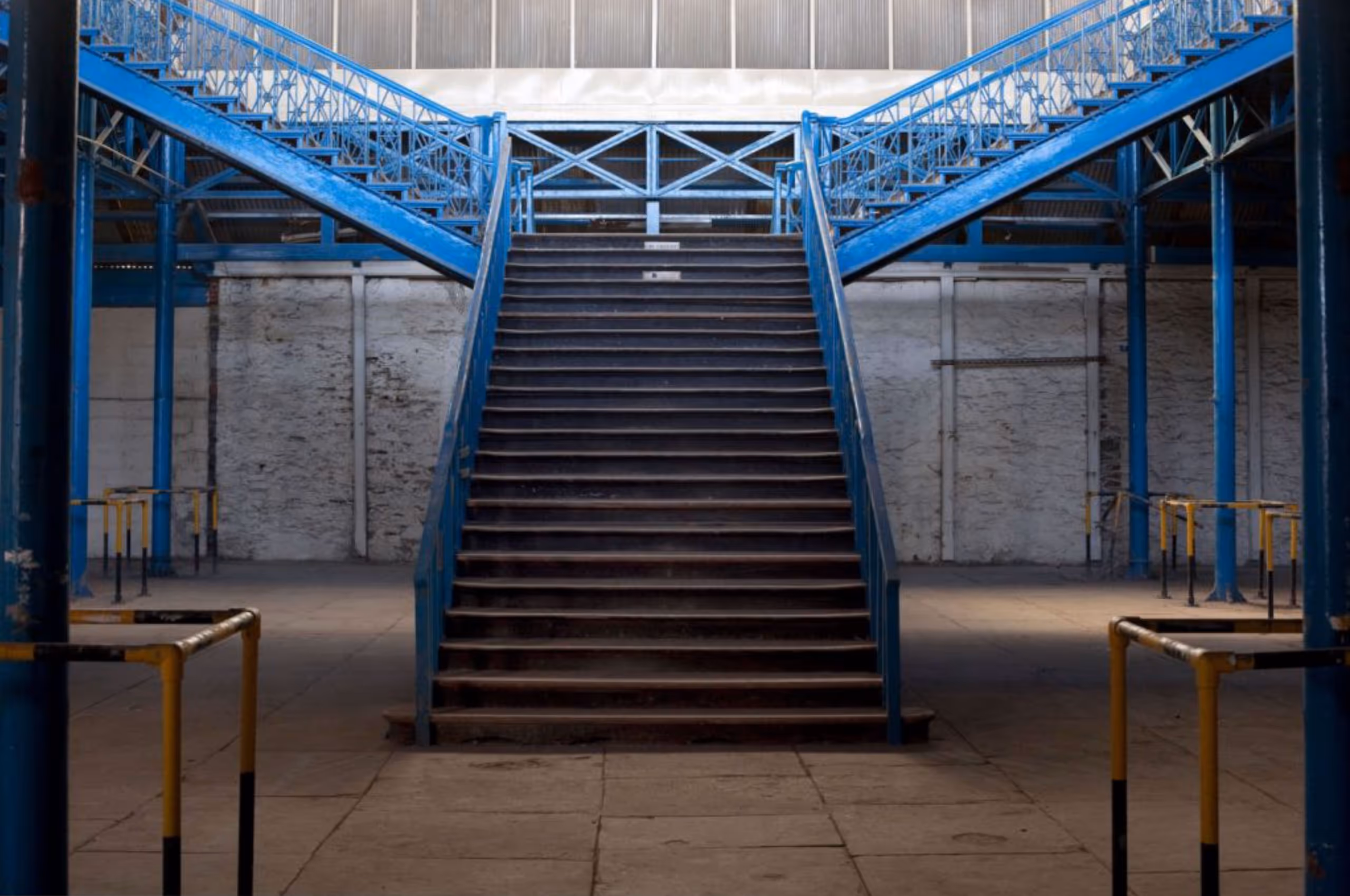 Blue painted metal staircase with railings inside Market Hall