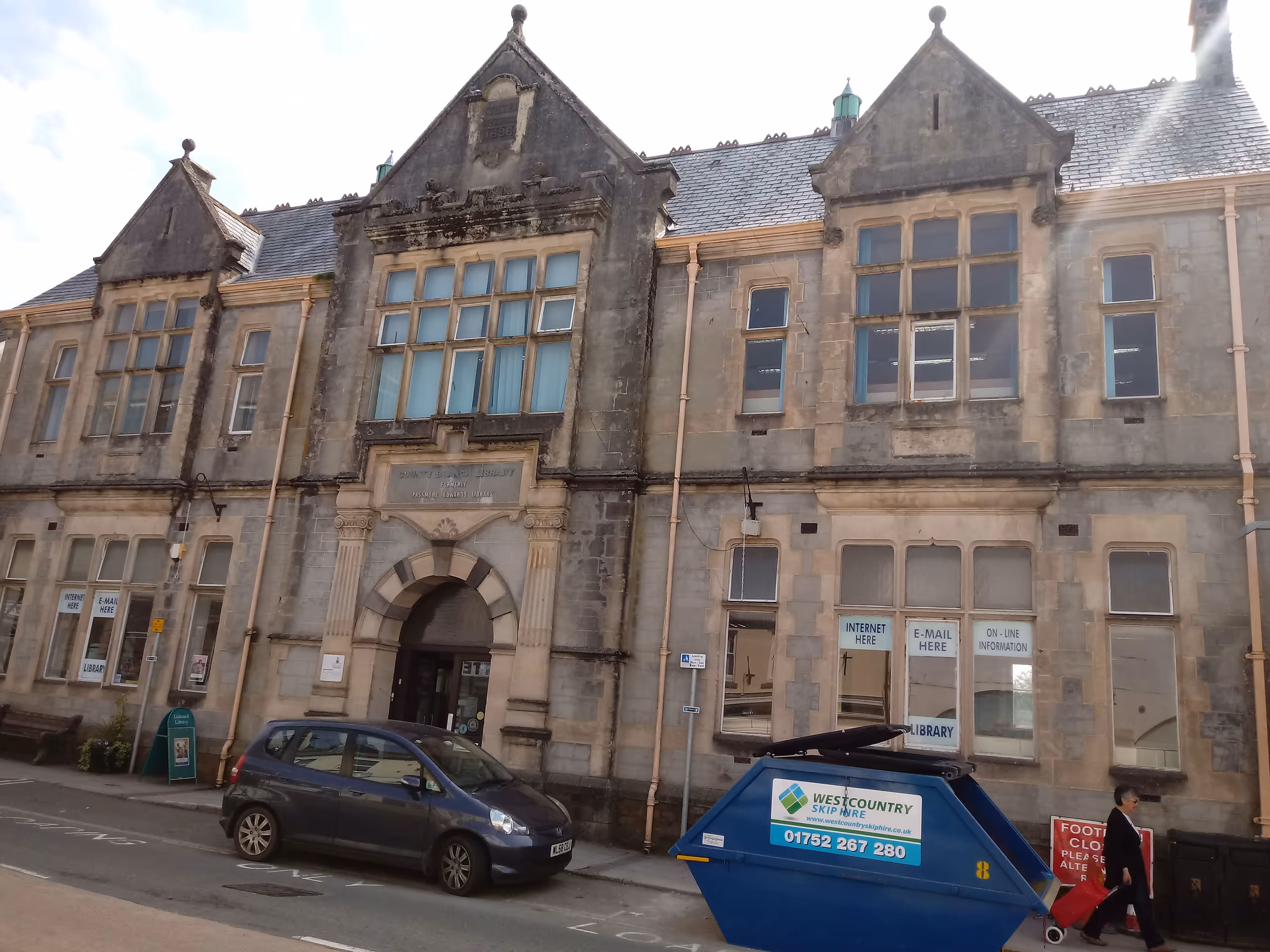 Liskeard Library, victorian stone building exterior with ornate architecture, arched entrance, and weathered facade