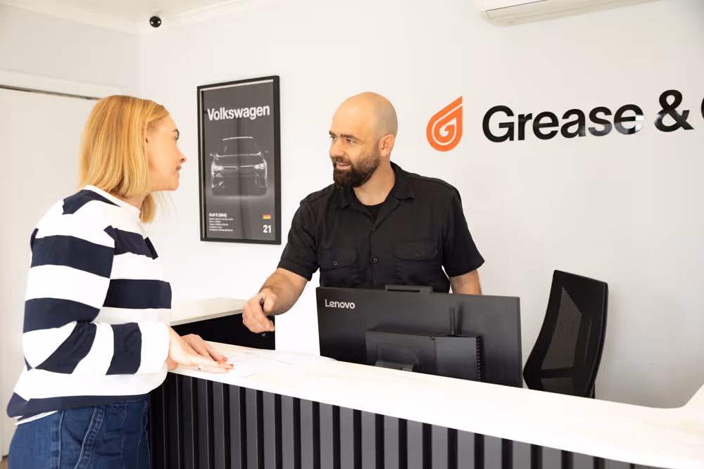Domenic from Grease and Oil Wollongong greeting a female customer in his very comfortable workshop lobby in wollongong cbd