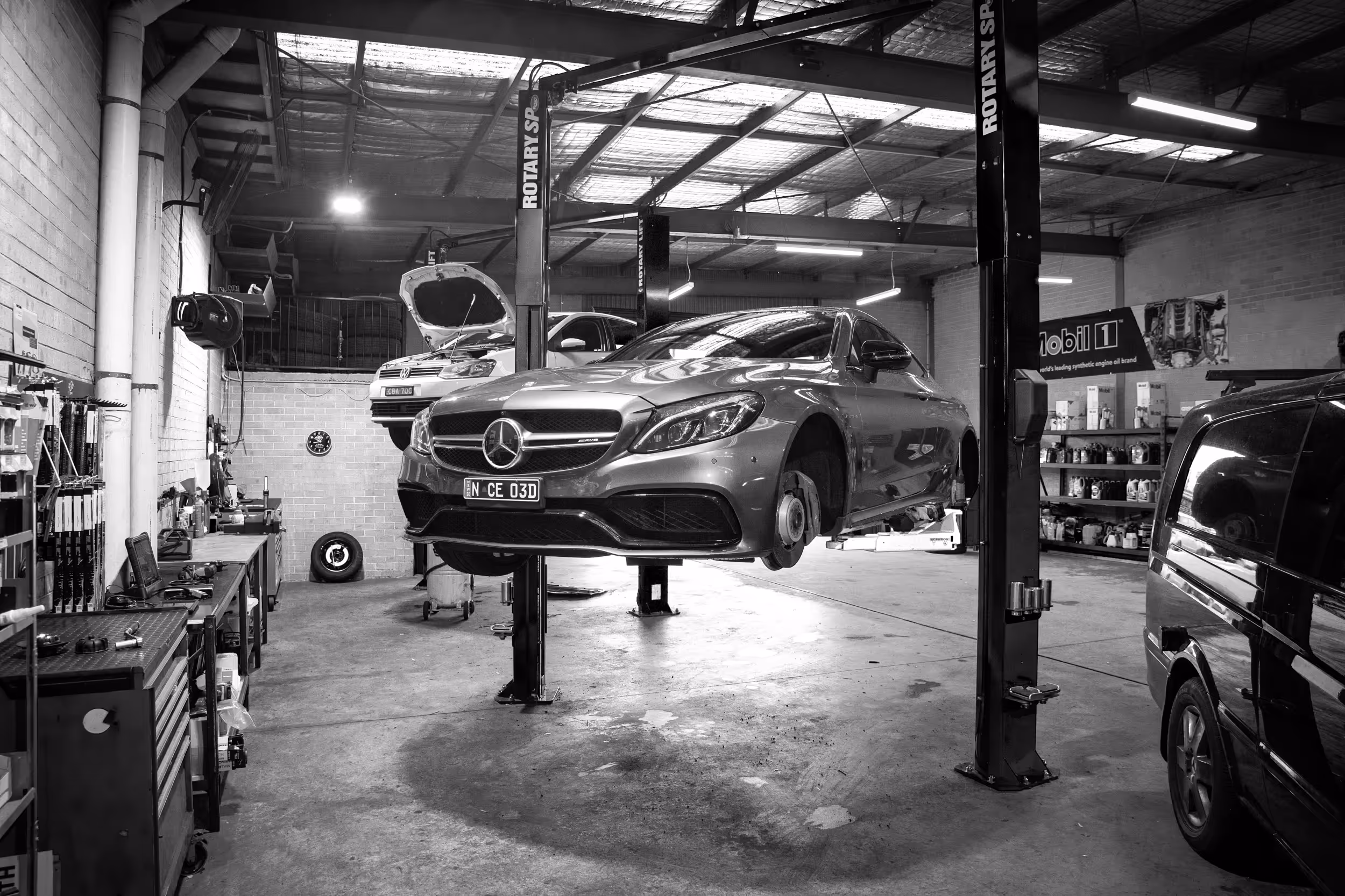 Grease and Oil Automotive workshop photo with a AMG, volkswagen, and renault on hoists. Warranty servicing and logbook servicing by the best and most honest mechanic in wollongong