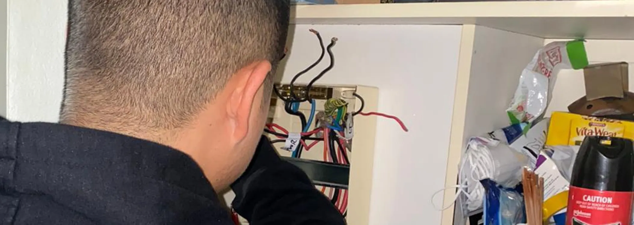 electrician identifying and troubleshooting electrical faults in a wiring system