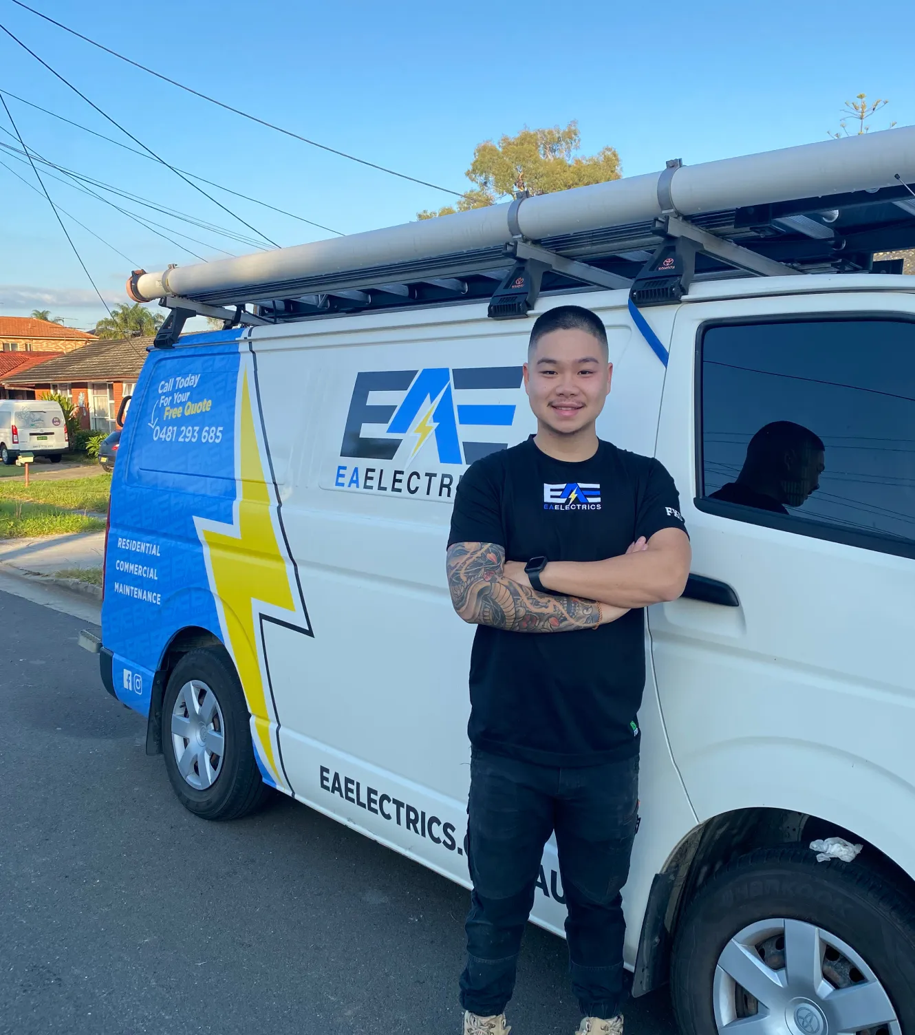 Image of Patrick from EA Electrics standing next to the company's service van
