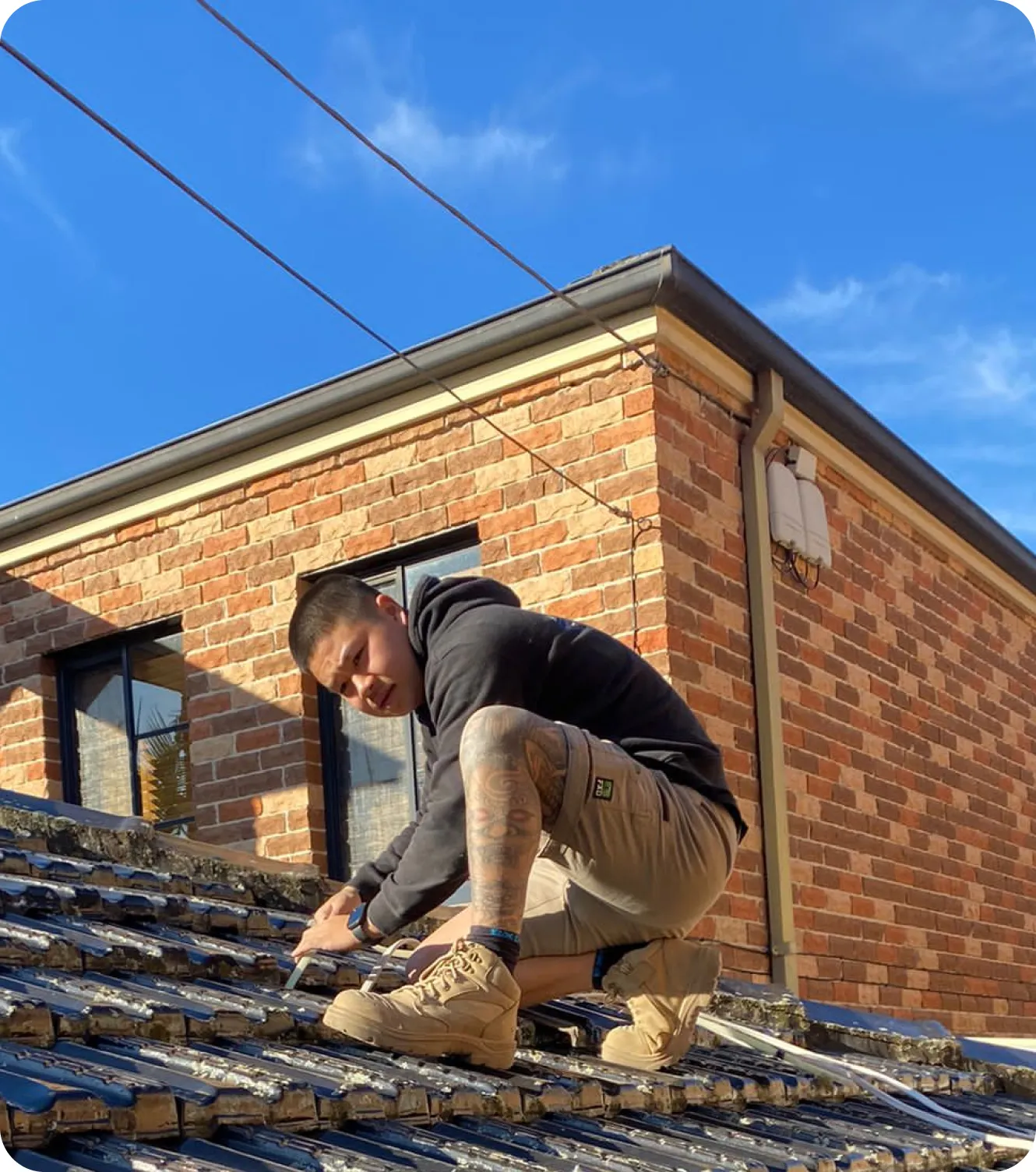 Image of Electrician Patrick, from EA Electrics, working on a roof