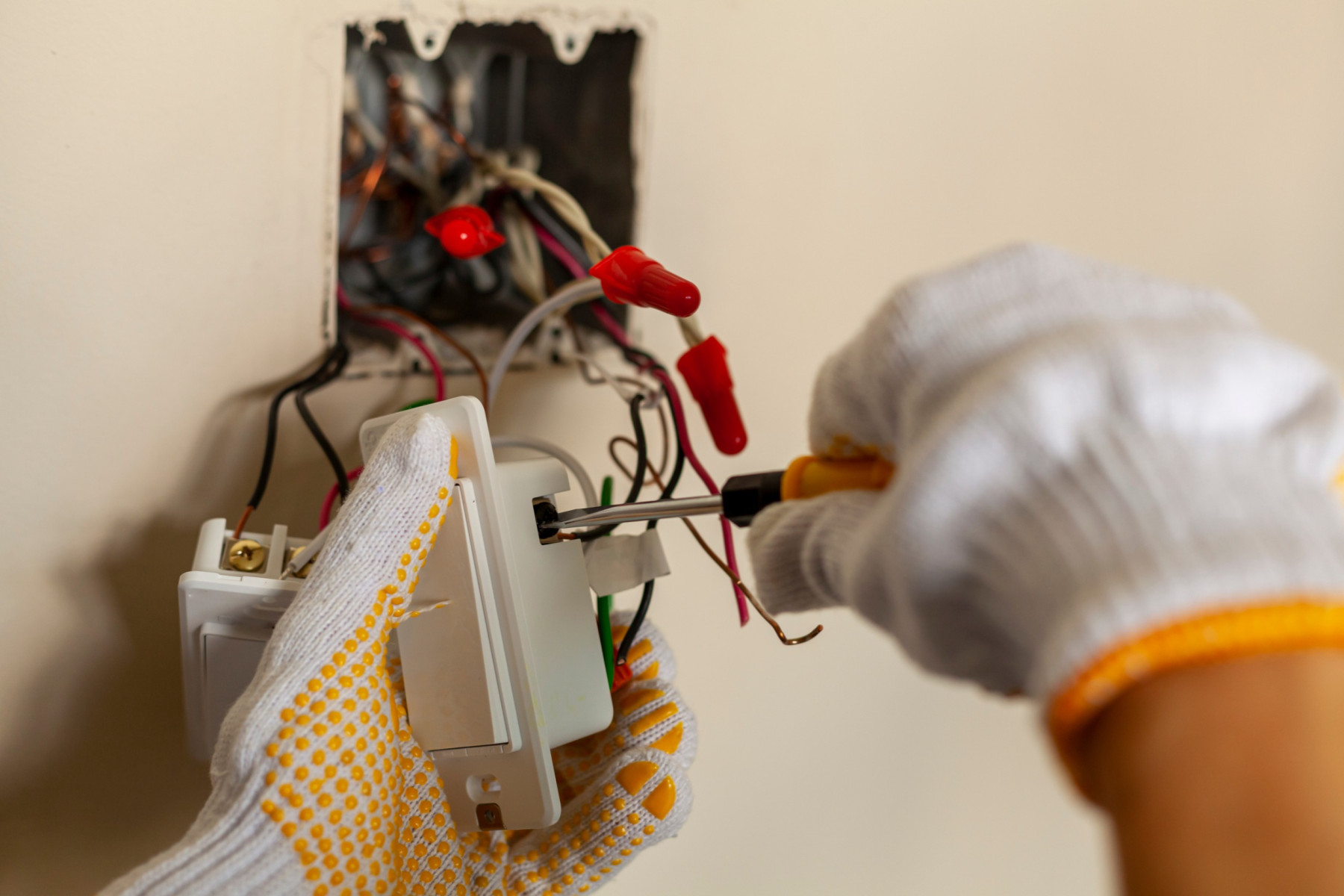 Professional electrician diagnosing electrical issues