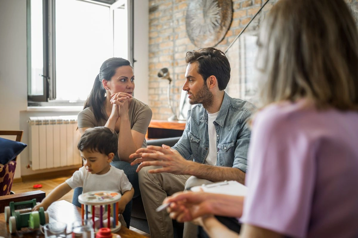 Parents sitting with their young child during a family counselling session