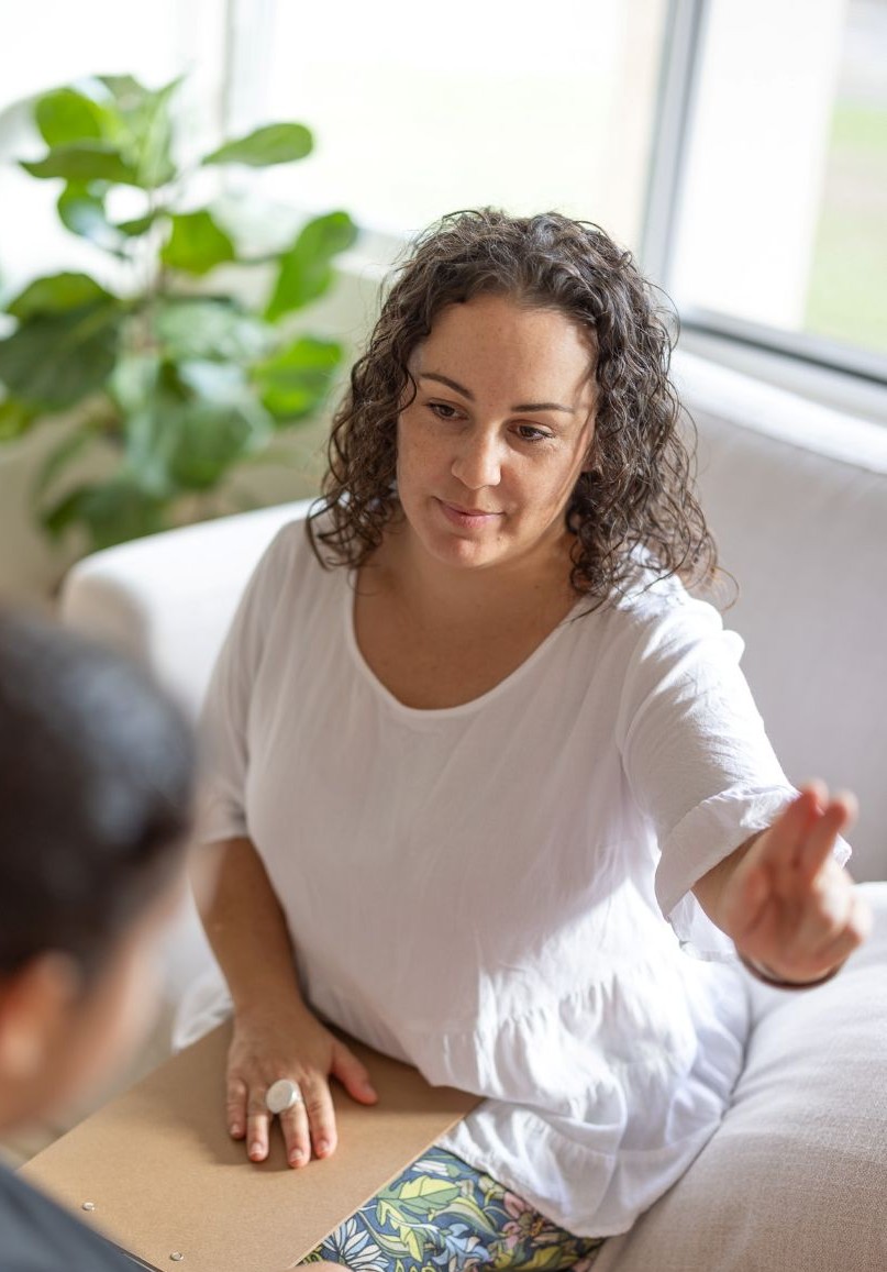 Jakara Enders sitting on a couch during an EMDR therapy session