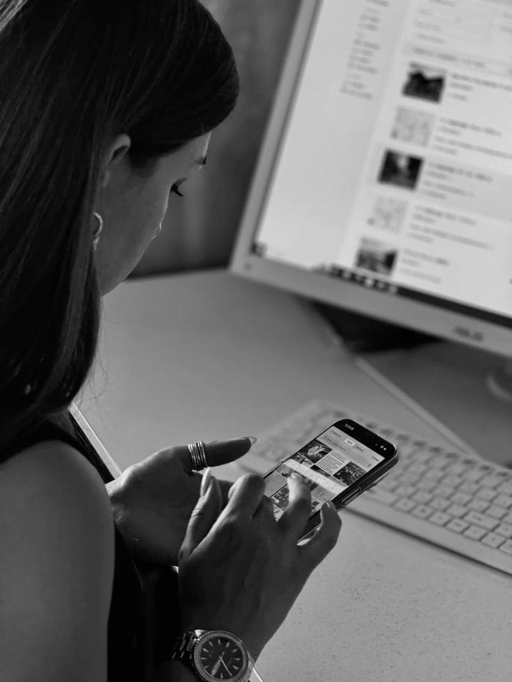 young woman looking at her phone at the work