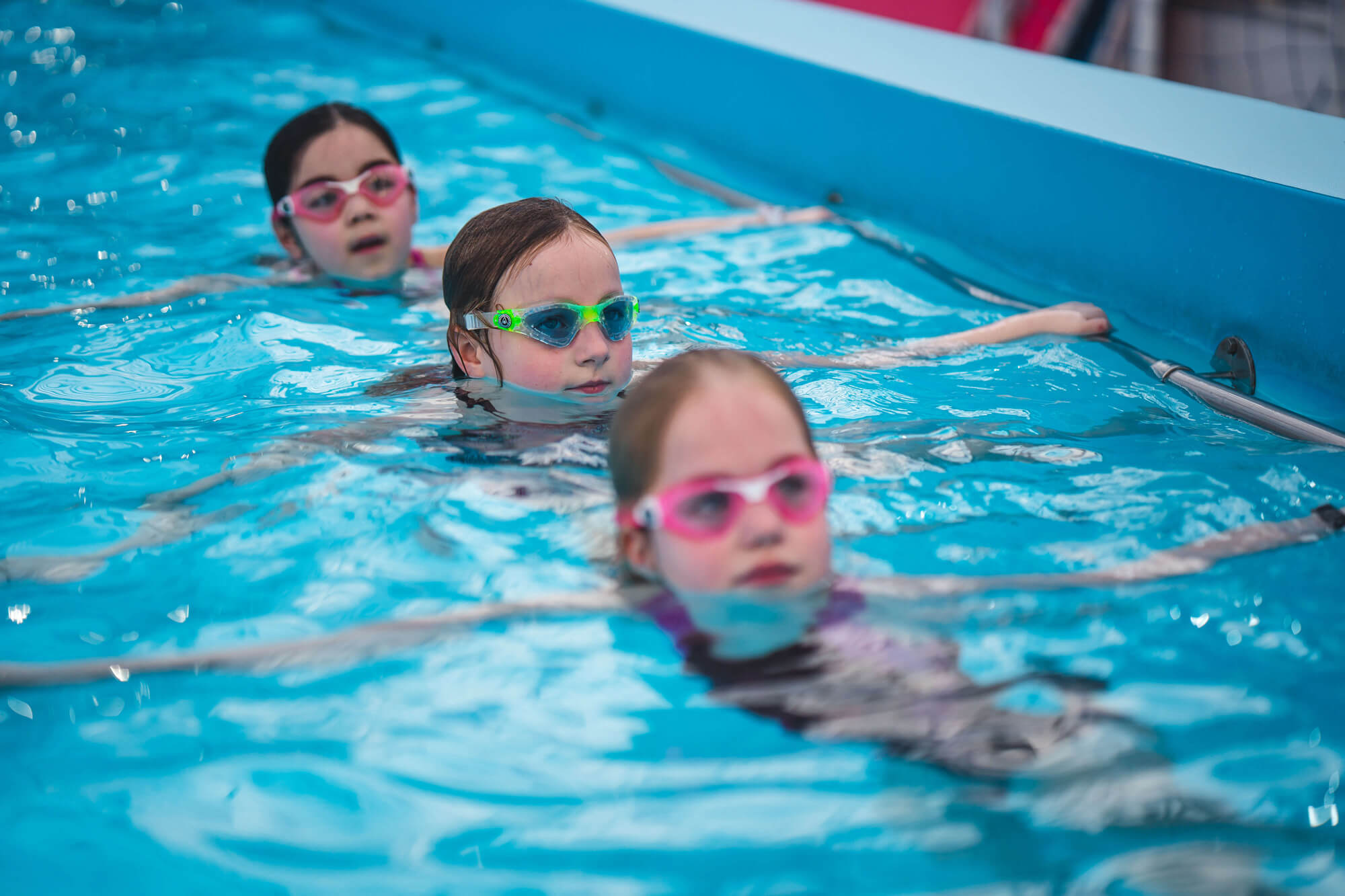 3 young girls at a swimming lesson