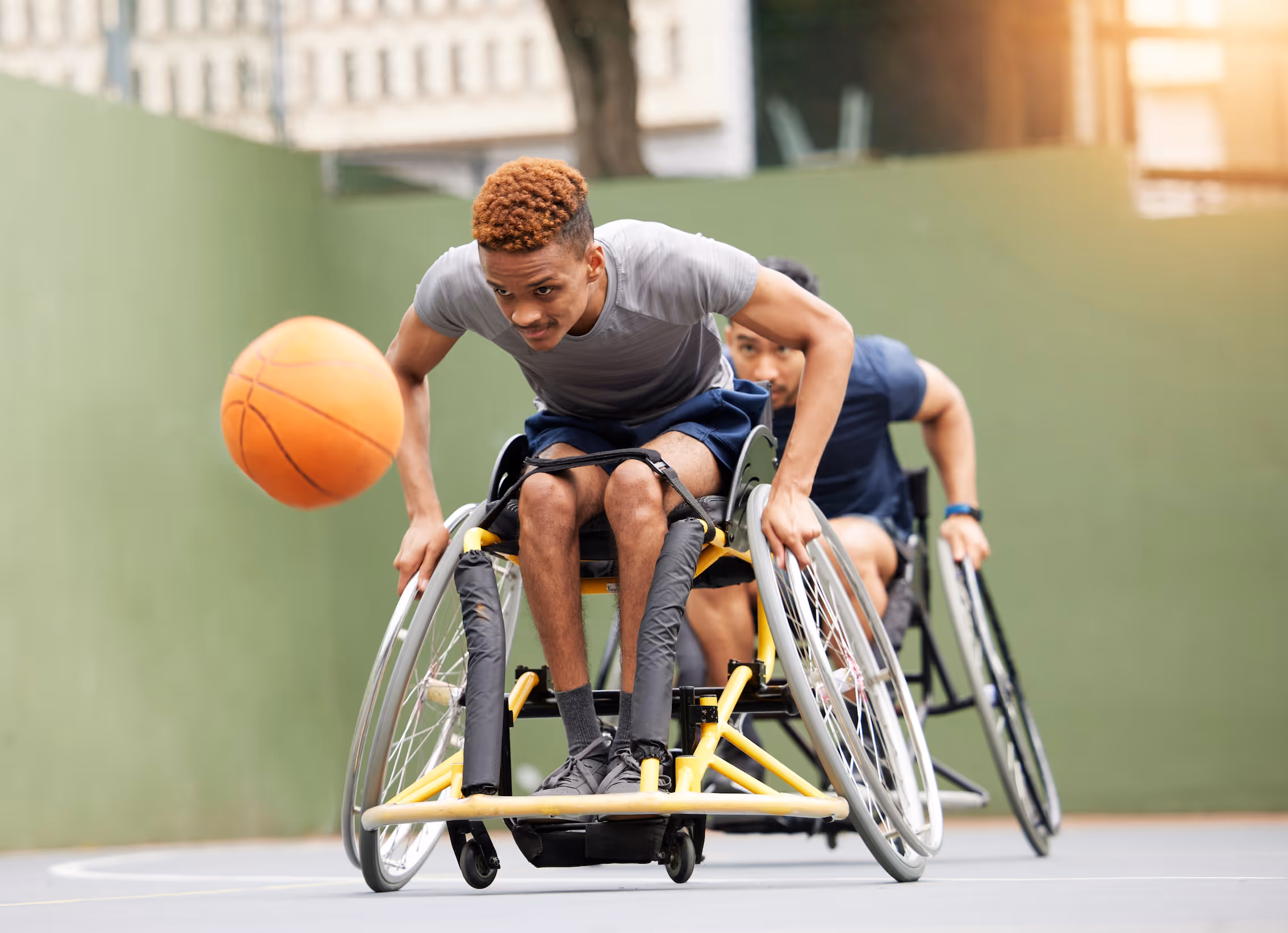 a young man in the wheel chair playing basketball