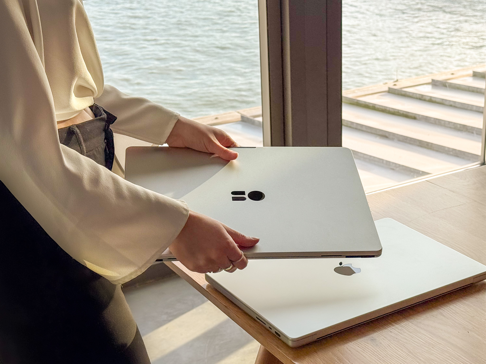 “Closed Standout aluminum portable monitor on a desk beside camera and smartphone.