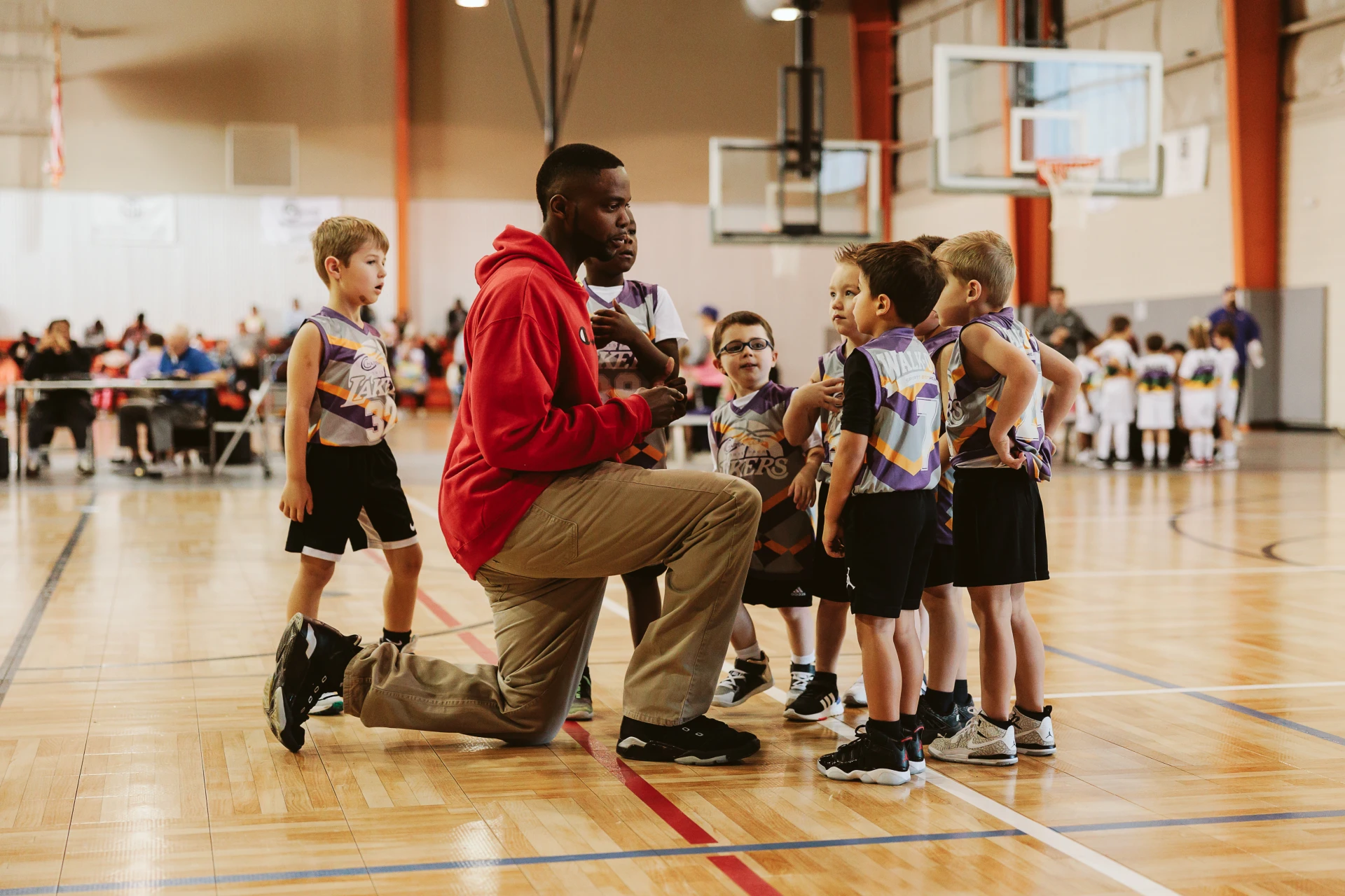 Coach teaching kids at basketball