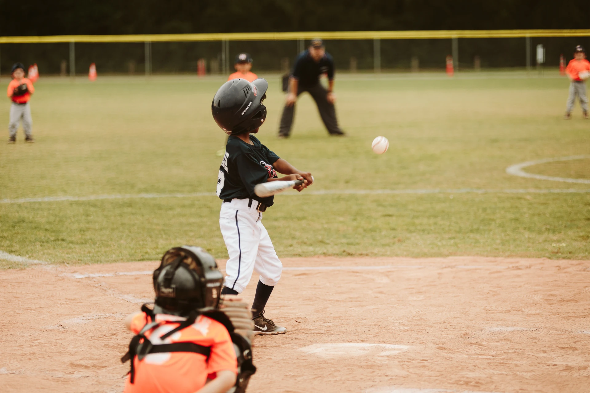 Kid hitting baseball