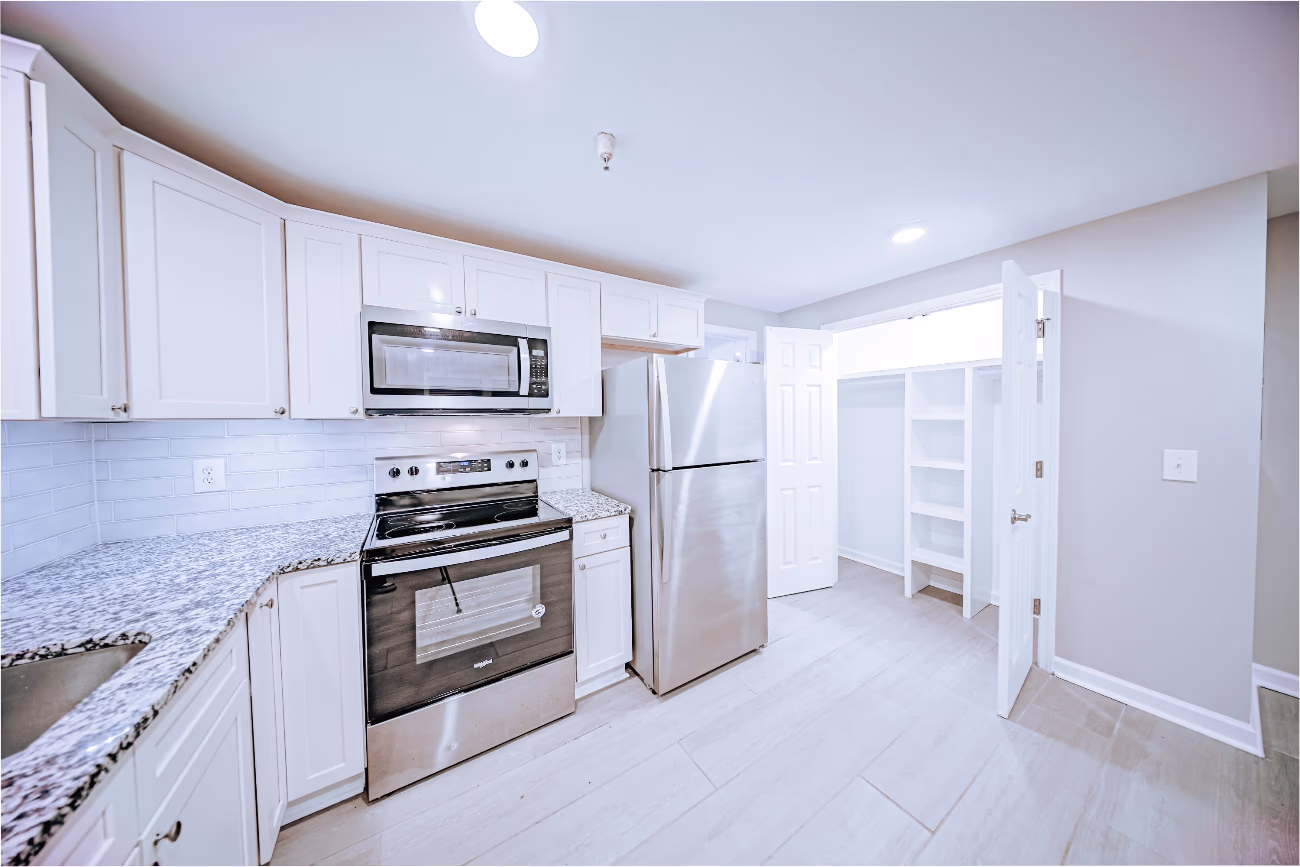 Modern kitchen interior with stainless steel appliances at Victorian Village Apartments in Marietta GA