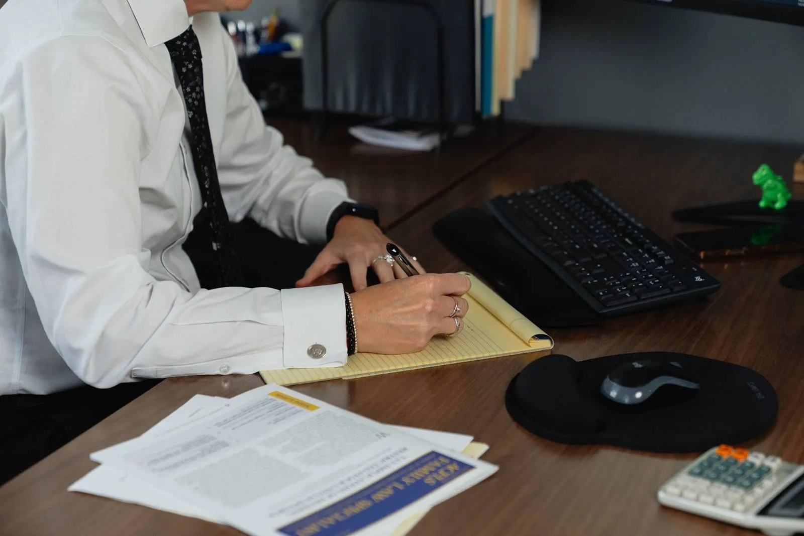 Cage & Miles partner and family law attorney, Jillian Duggan-Herd, writes at desk.