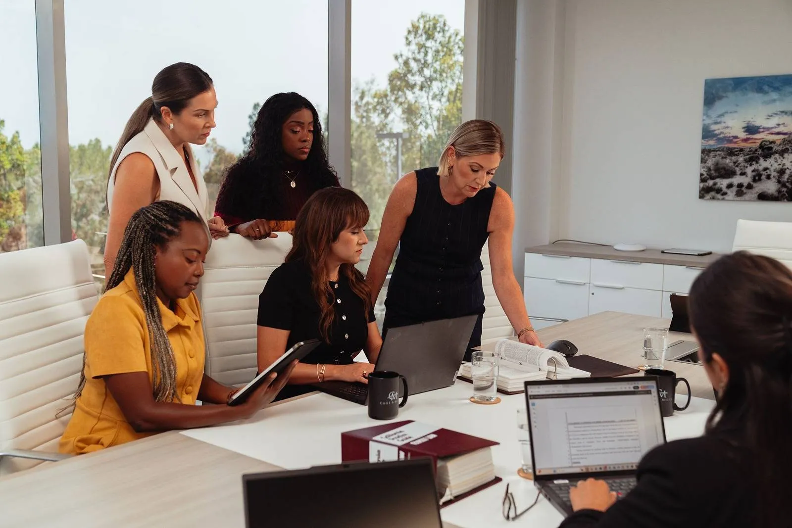 Cage & Miles founding partners Shannon Miles and Jaime Cage lead team meeting at the office.