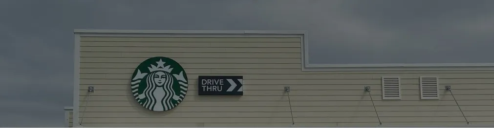 Minimalist drive-thru signage on Starbucks building exterior