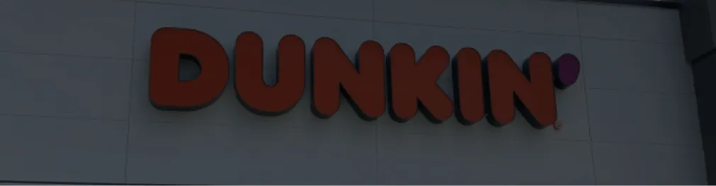 Wall-mounted Dunkin’ logo sign with flat letter design