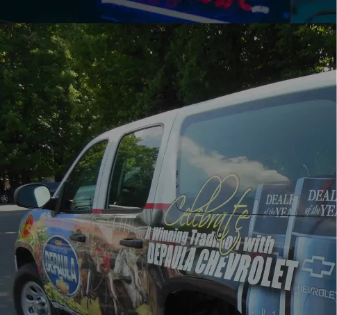 SUV wrapped with full-color graphics for Depaula Chevrolet, featuring a celebration of dealership awards.