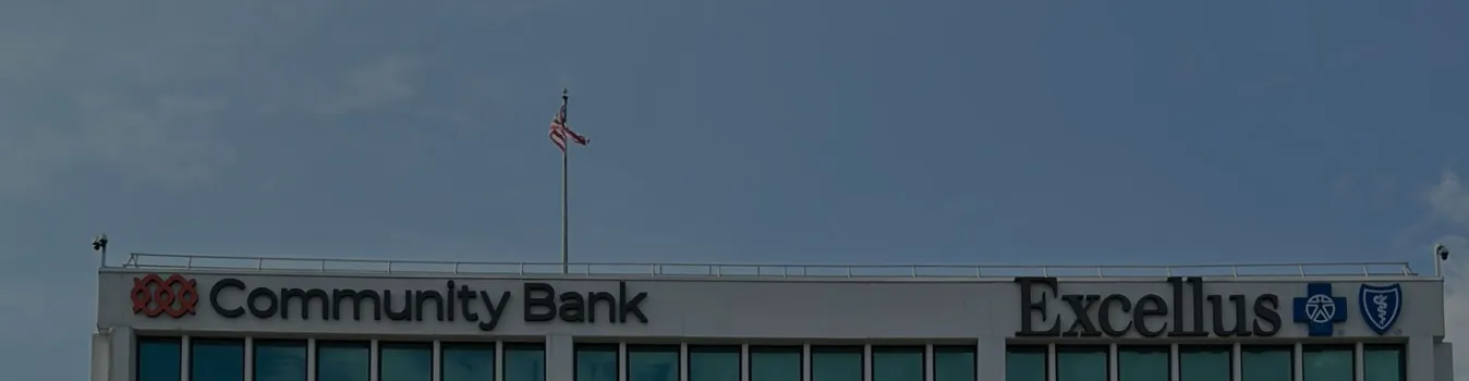 Community Bank and Excellus BlueCross BlueShield signage on top of corporate building