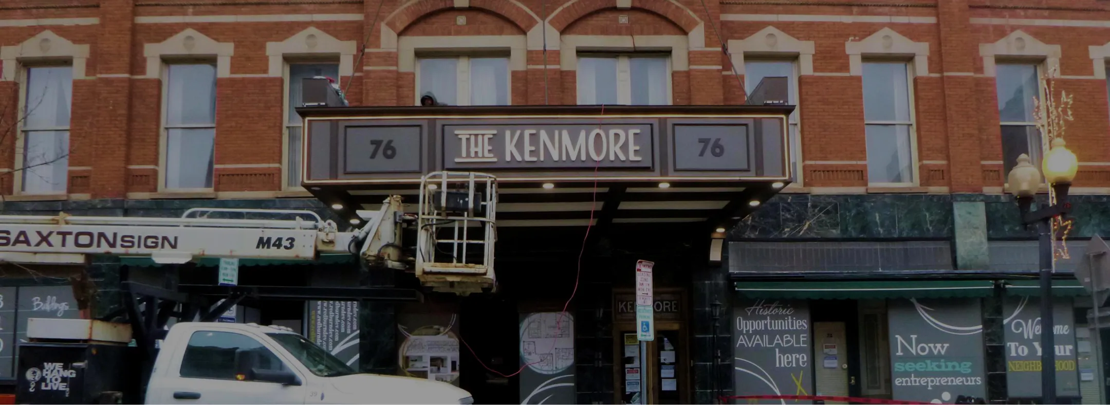 Saxton Sign Corp team working on The Kenmore theater marquee at a historic brick building.