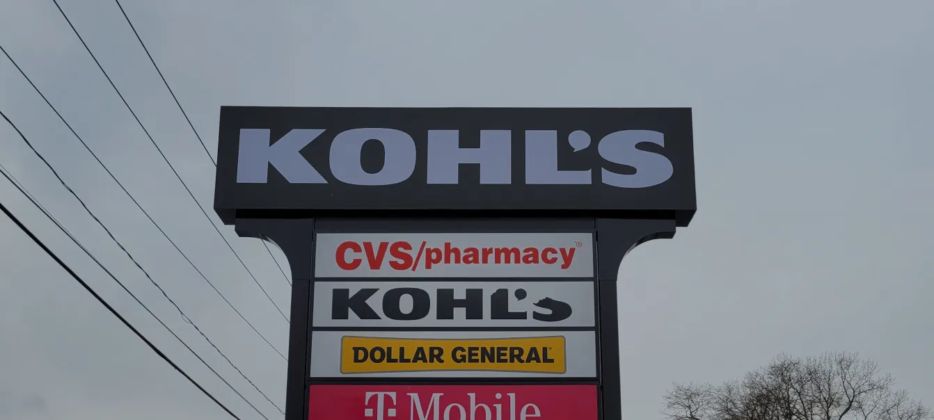 Shopping plaza pylon sign displaying Kohl's, CVS Pharmacy, Dollar General, and T-Mobile logos