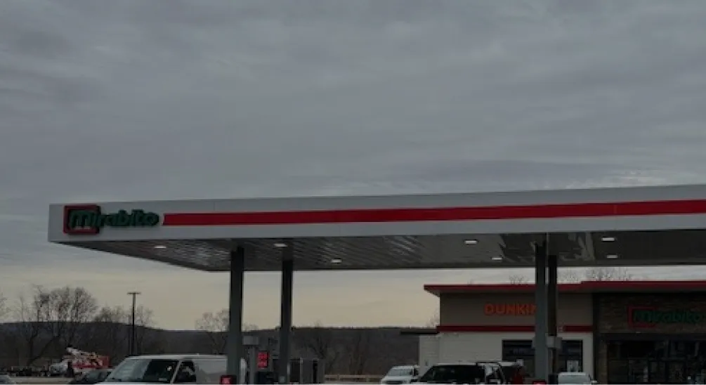Mirabito gas station canopy featuring red and green branding under cloudy sky