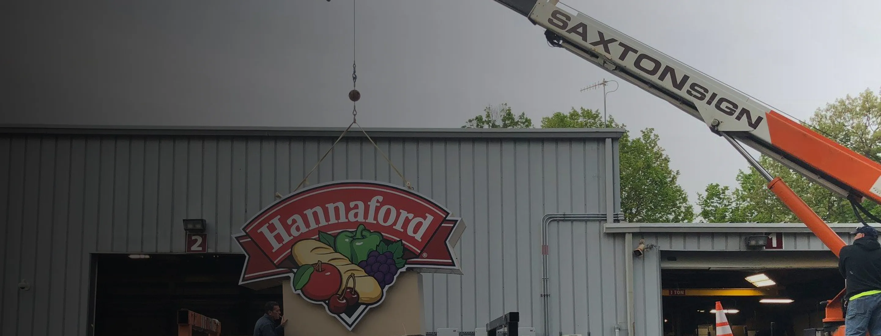 Crane lifting Hannaford store sign
