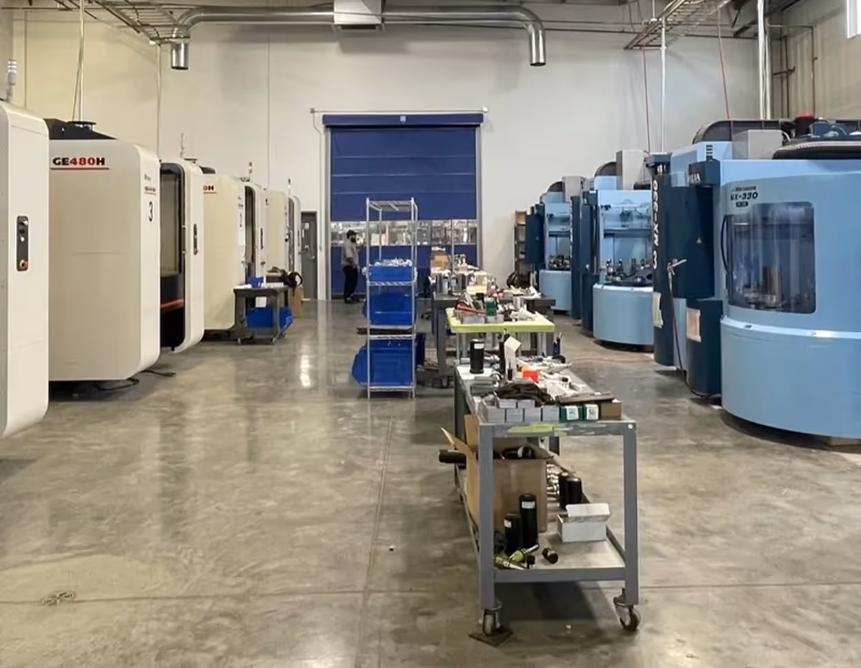 Workshop with multiple CNC machines and tool carts.