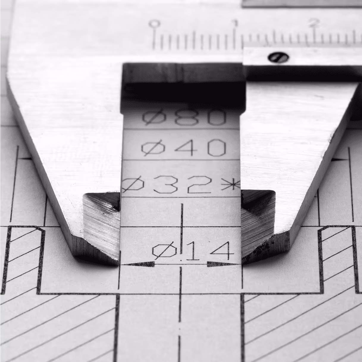 Vernier caliper measuring a part on a technical drawing.