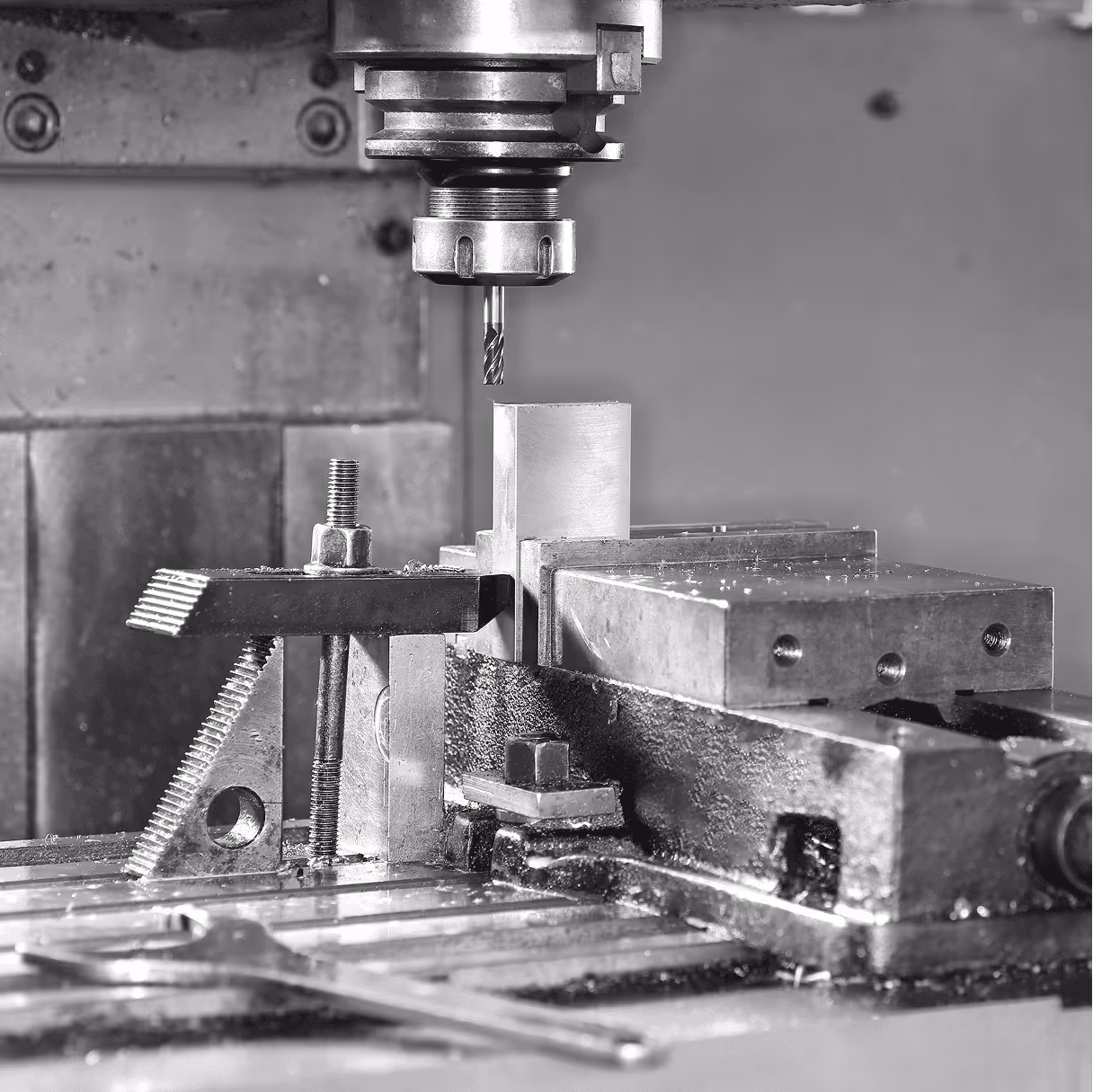 Milling machine cutting a metal block.