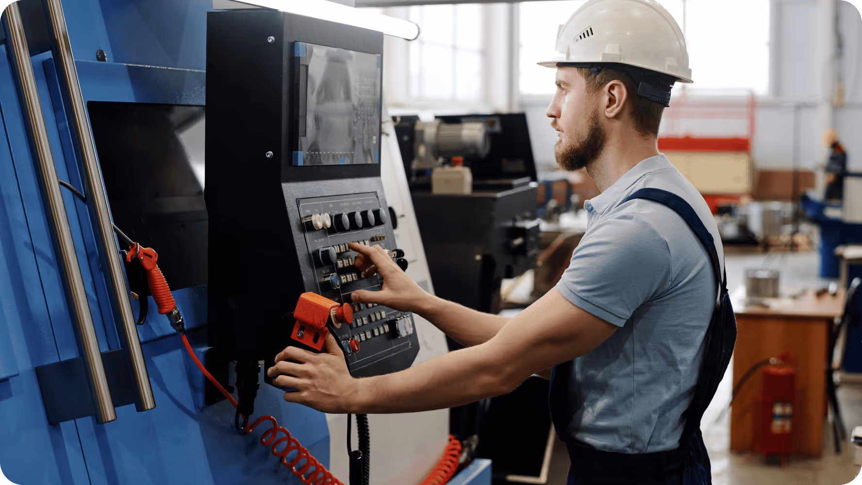 Operator using control panel of a CNC machine.