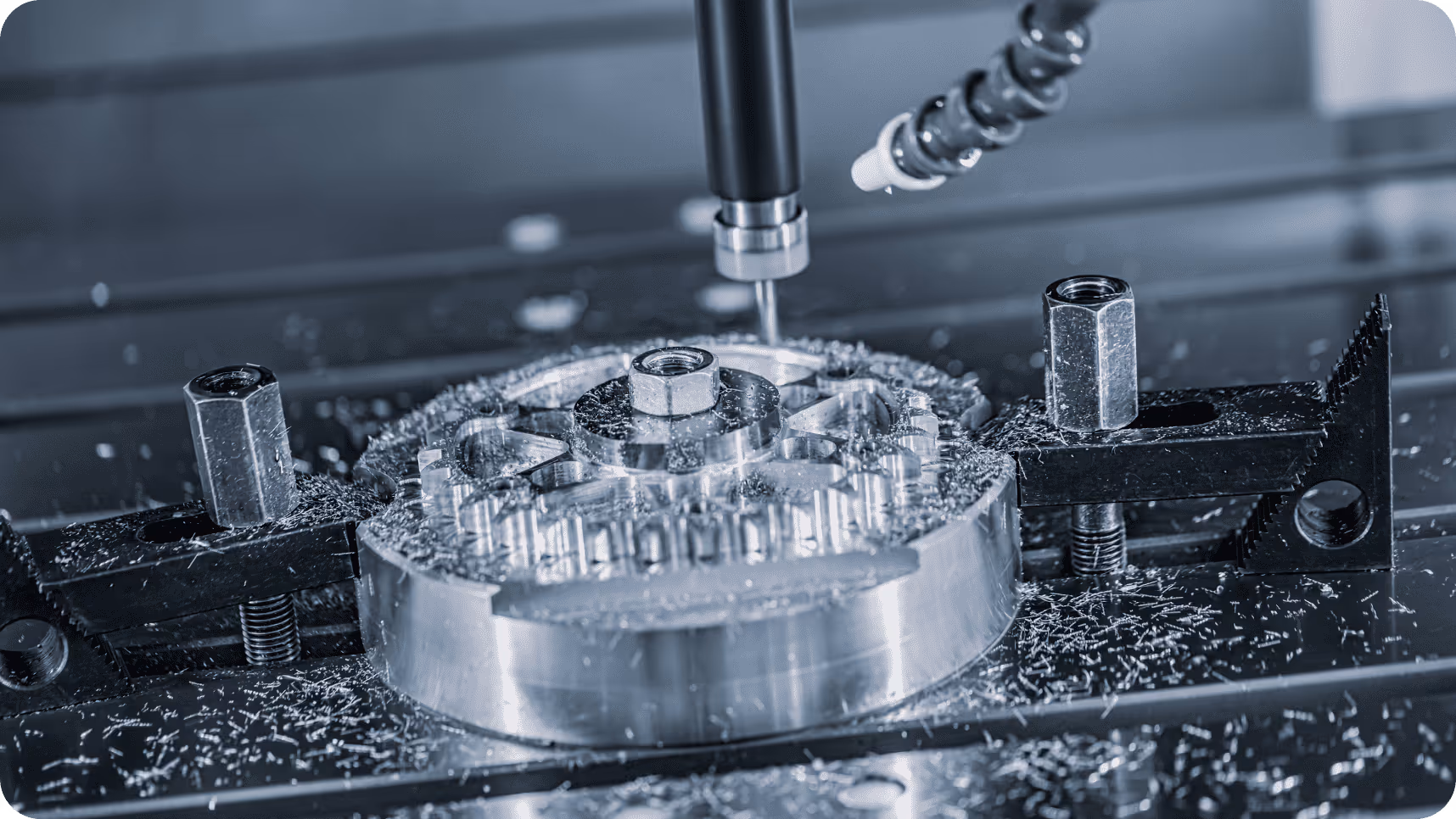 CNC milling machine cutting a circular metal part with coolant spray.